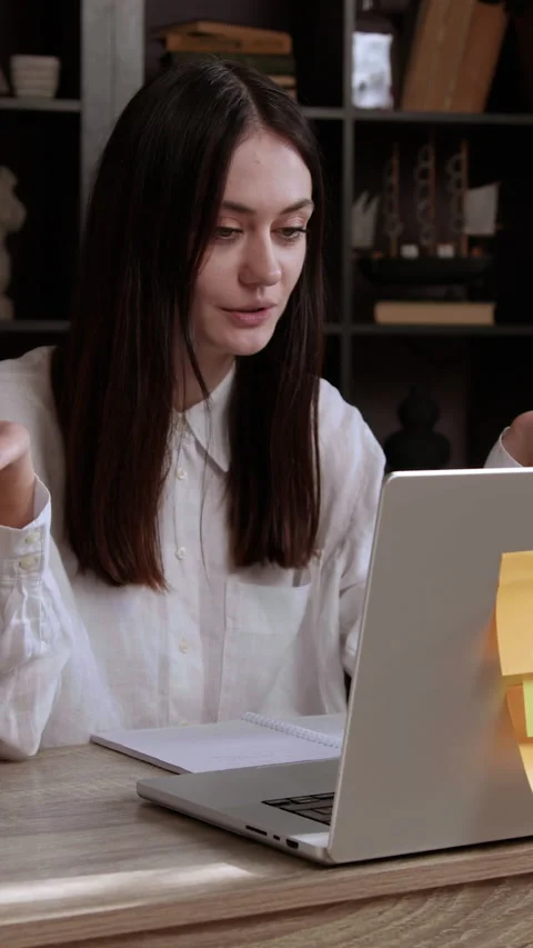 Expressive student speaks in front of a computer participating in a public Stock Footage 305410582