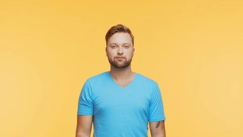 Expressive young man over vibrant background. Studio portrait of handsome person Stock Footage 123545781