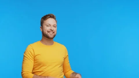 Expressive young man over vibrant background. Studio portrait of handsome person Stock Footage 123859564