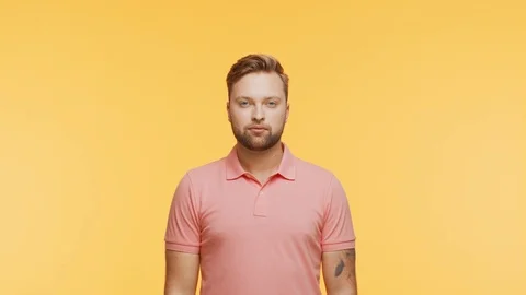 Expressive young man over vibrant background. Studio portrait of handsome person Stock Footage 123995252