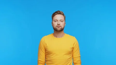 Expressive young man over vibrant background. Studio portrait of handsome person Stock Footage 125510780