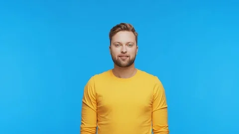 Expressive young man over vibrant background. Studio portrait of handsome person Stock Footage 125510865