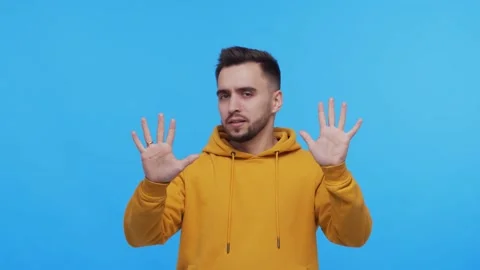 Expressive young man over vibrant background. Studio portrait of borred person. Stock Footage 137669223