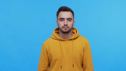 Expressive young man over vibrant background. Studio portrait of borred person. Stock Footage 137669247