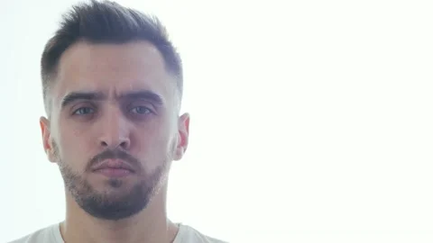 Expressive young man over window background. Home portrait of smiling handsome Stock Footage 130232153