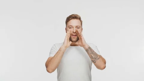 Expressive young man screaming and shouting over vibrant background. Portrait of Video stock 123995044