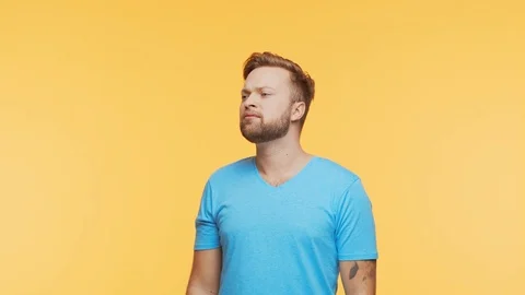 Expressive young man screaming and shouting over vibrant background. Portrait of Stock Footage 125170649