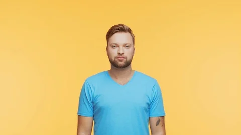 Expressive young man screaming and shouting over vibrant background. Portrait of Stock Footage 125789974