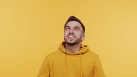 Expressive young man screaming and shouting over vibrant background. Portrait of Stock Footage 137669235