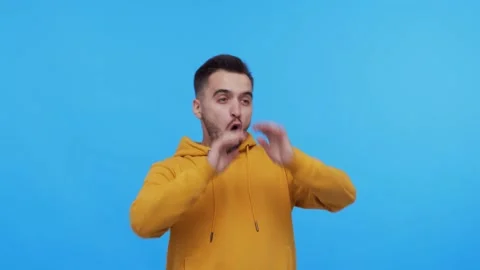 Expressive young man screaming and shouting over vibrant background. Stock Footage 137669344