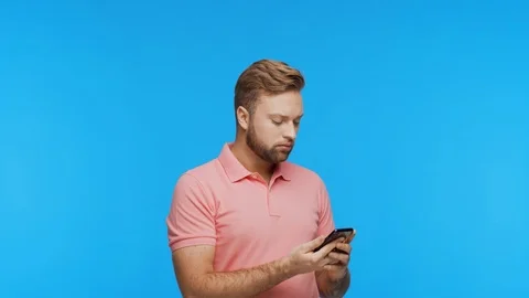 Expressive young man with a smartphone over vibrant background. Portrait of Stock Footage 123859416