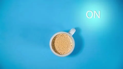 Expresso coffee in a white mug on a colored background with the text off and Stock Footage 137409394