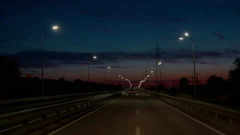 Expressway in the dark. Moving forward towards the sun. A road between cities Stock Footage 158825513