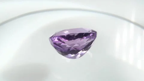 Exquisite Amethyst Gemstone Displayed on a Reflective Surface Stock Footage 285454225
