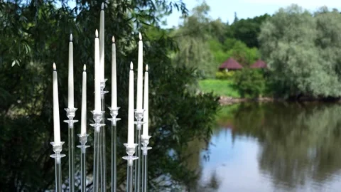 Exquisite and beautiful composition of glass and candles on the lake shore Stock Footage 310605272