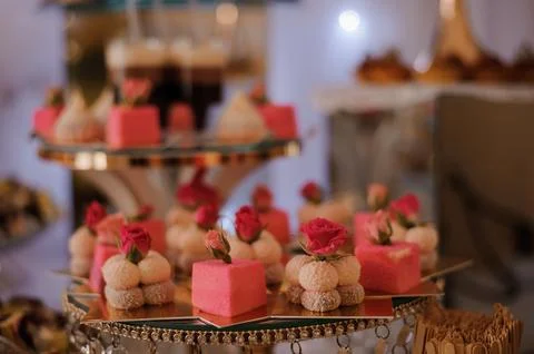 Exquisite Array of Pink and White Floral Desserts on a Decorative Serving P.. Stock Photos