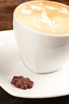 Exquisite cappuccino presentation featuring an intricately adorned cup Stock Photos