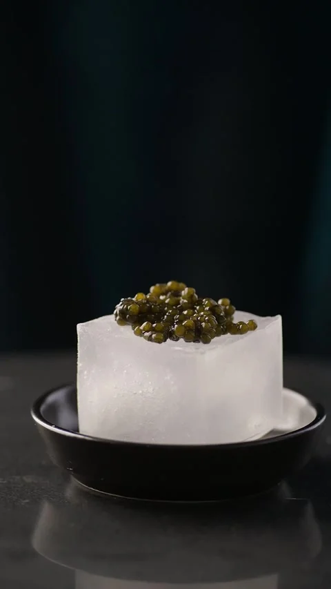 Exquisite close-up video showcasing lustrous beluga caviar carefully placed atop Video stock 330616393