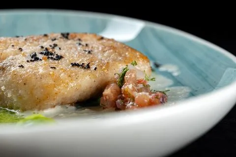 This exquisite dish features panseared fish with a vibrant herb sauce and fla Photos