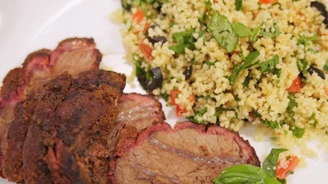 An exquisite dish of fried meat with an elegant side dish awaits on the table Stock Footage 272948423