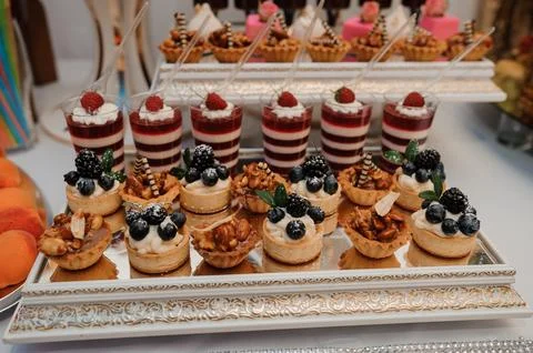 An Exquisite Display of Elegant Desserts Featuring Tartlets, Creams, and Fr.. Stock Photos
