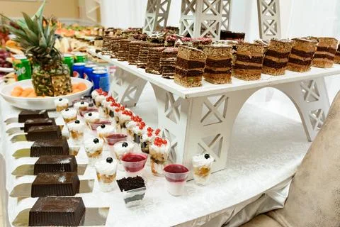 Exquisite festive table with sweets and fruits. 스톡 사진