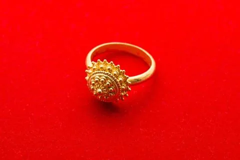 Exquisite Golden Ring on Red Background Photos