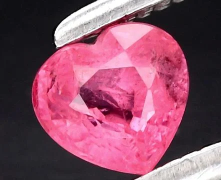 Exquisite Heart-Shaped Pink Ruby Gemstone Sparkling with Radiance and Eleganc Stock Photos