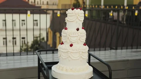 Exquisite MultiTier Wedding Cake Beautifully Displayed in an Outdoor Setting Video stock 318065595