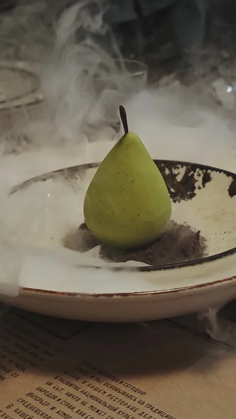 Exquisite pear shaped mousse dessert on a bed of chocolate crumble Stock-Footage 346185407