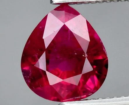 Exquisite Pear-Shaped Ruby Gemstone with Intricate Facets and Radiant Color Stock Photos