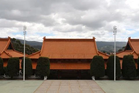 Exquisite traditional architecture of a temple complex under cloudy skies i.. Stock Photos