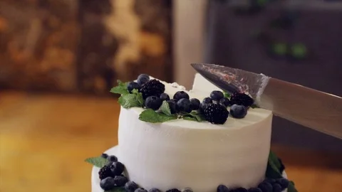 Exquisite wedding cake cut with a knife Stock Footage 99336431