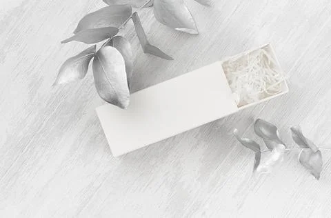 Exquisite white blank open rectangle gift box with paper filler mock up on wo Stock Photos