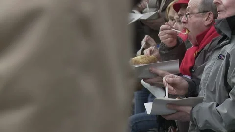Ext Day Cardiff - public consuming chips on Caroline Street Stock Footage 170003345