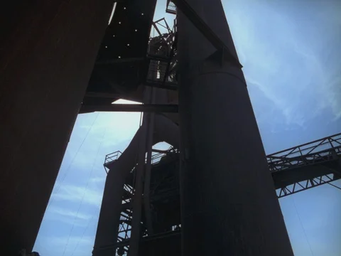 EXT DAY STEEL MILL - HIGH ANGLE WIDE TRUCK MOVING IN BG Stock Footage 75372429