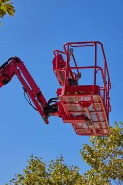Extendable cherry picker with hydraulic arm and close up on cradle with safet Stock Photos