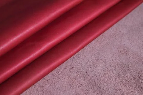 Extended and folded red leather fabric. Stock Photos