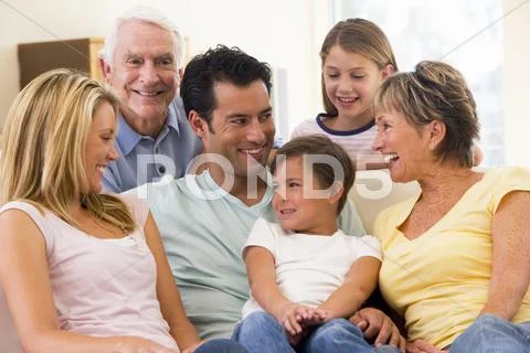 Extended family in living room smiling Stock Photos