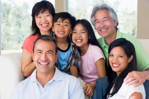 Extended family in living room smiling Stock Photos