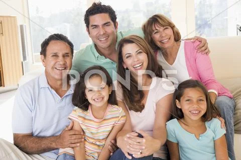 Extended family in living room smiling Stock Photos