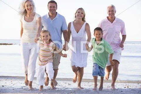 Extended family walking on beach Stock Photos
