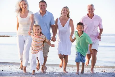 Extended family walking on beach Stock Photos