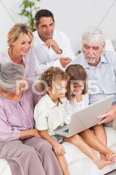 Extended family watching laptop Stock Photos