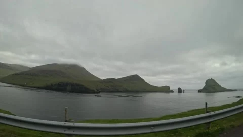 Extended road trip tracking shot along scenic coastal road in Faroe Islands Stock Footage 337535000