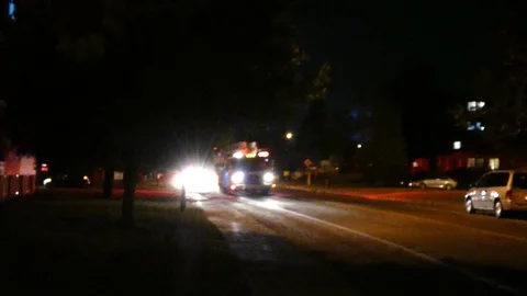 Extended shaky scene of news stringer filming firetruck arrival at fire Stock Footage 97684597