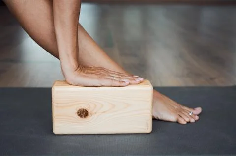Extended triangle pose with brick closeup, utthita trikonasana pose Stock Photos