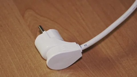 Extender for sockets, electrical appliance plug and watt meter on wooden surface Stock Footage 102913860