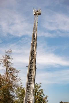 Extending aerial platform from fire engine reaching high into a blue sky Photos