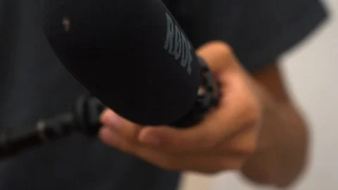 Extending a boom pole with microphone Stock Footage 107325671